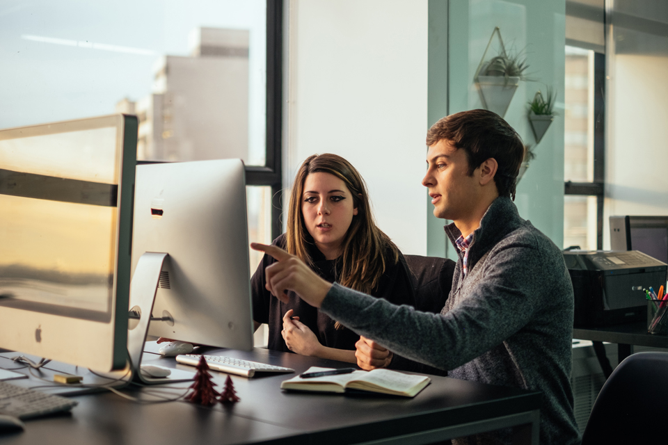 Austin Stone directing a designer at the Beck & Stone office in New York City.